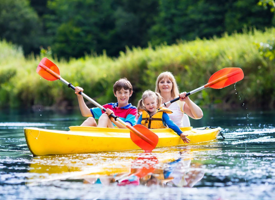 family kayaking in muskoka